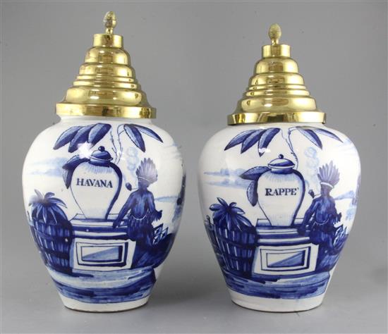 A near pair of Dutch delft blue and white tobacco jars and brass covers, late 18th century, height 25.5cm